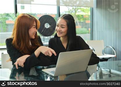 Asian business women working and using laptop in meeting room