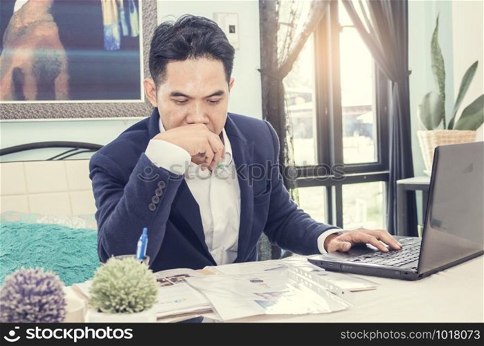Asian businessman analyzing data in office