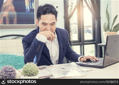 Asian businessman analyzing data in office