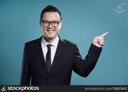 Asian businessman finger pointing to the side . figure out and guiding concept .