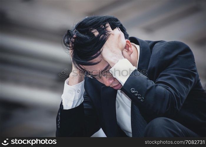 asian businessman sad worry tired and headache, stress at workplace, feeling ill, finance problem and lost job, close up shot background