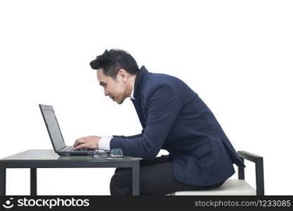 Asian Businessman sitting at a desk using a laptop on white background