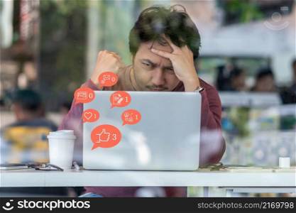 Asian businessman working in serious and exhausted action when checking social network very bad feedback with number of Like, Love, comment, people and fovorite icon.Social media disease concept,