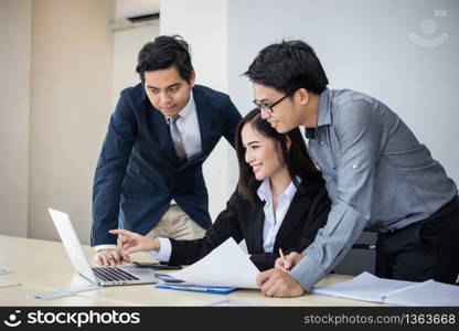 Asian businessmen and group using notebook for business partners discussing documents and ideas at meeting and business women smiling happy for working