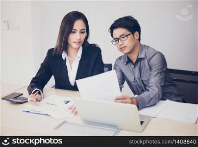 Asian businessmen and group using notebook for business partners discussing documents and ideas at meeting and business women smiling happy for working