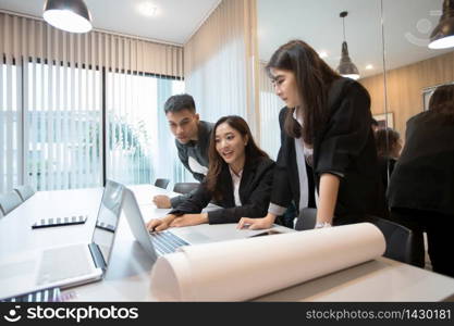 Asian businessmen and group using notebook for meeting and business women smiling happy for working