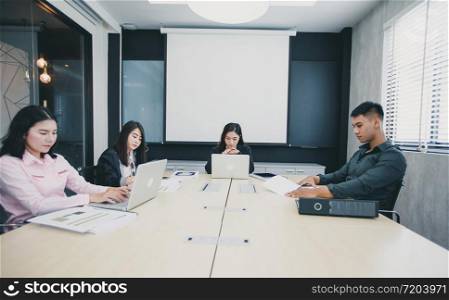 Asian businessmen and group using notebook for meeting serious about the work