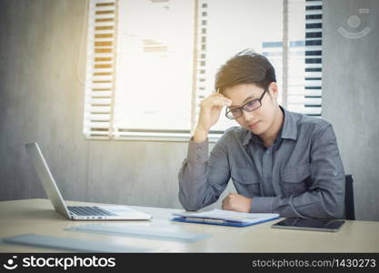 Asian businessmen serious about the work done until the headache and have notebook and document on table