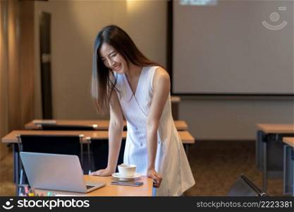 Asian Businesswoman in casual suit working with computer laptop and office supplies in modern office or meeting room, Business and worker concept