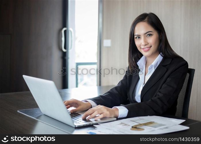 Asian businesswomen and group using notebook for business partners discussing documents and ideas at meeting and business women smiling happy for working