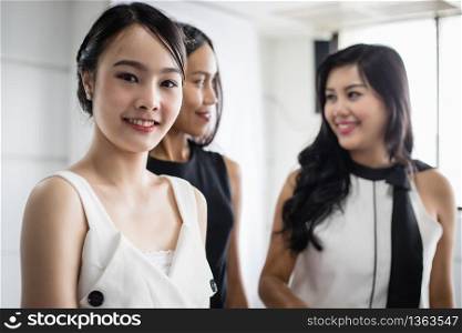 Asian Businesswomen with partner discuss about the detail of work on smartphone and business women smiling