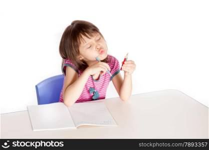 Asian caucasian girl doing homework at desk, back-to-school