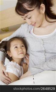 Asian child in bed with mum