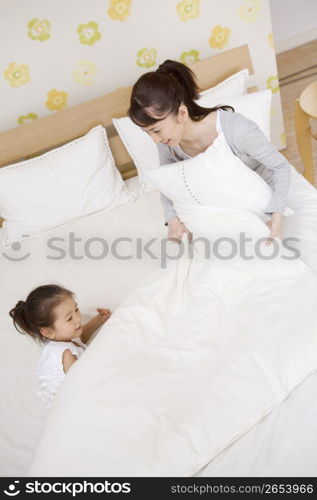 Asian child in bed with mum