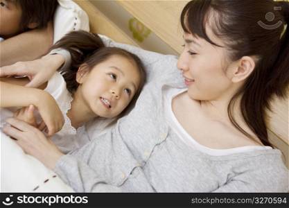 Asian child in bed with mum and dad