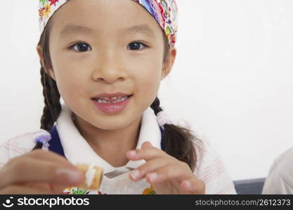 Asian child in cooking apron