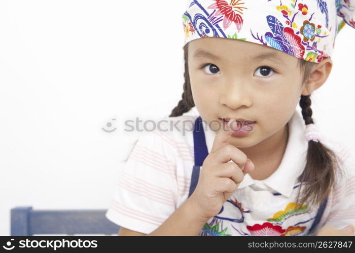 Asian child in cooking apron