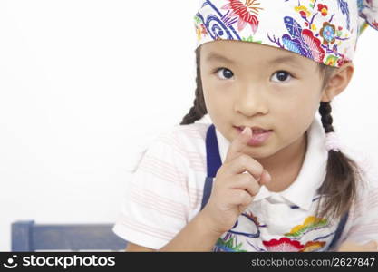 Asian child in cooking apron