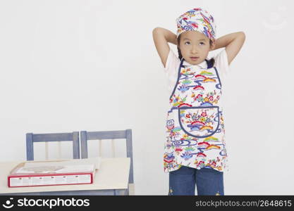 Asian child in cooking apron