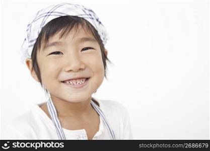 Asian child in cooking apron