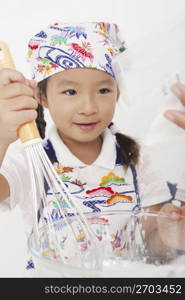 Asian child in cooking apron