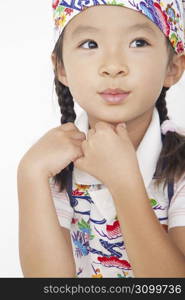 Asian child in cooking apron