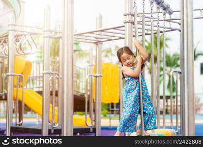 Asian child playing on outdoor playground, happy preschool little kid having funny while playing on the playground equipment in the daytime in summer, Outside education, Little girl climbing