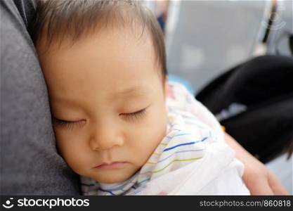 Asian children are sleeping outside of their father.