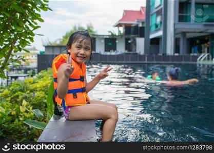 asian children happy smiling face in sport water pool