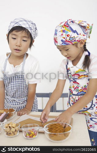 Asian children in cooking apron