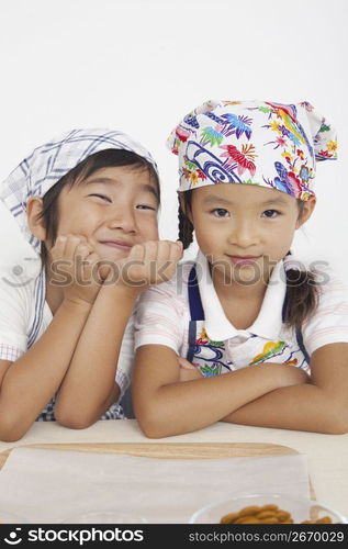 Asian children in cooking apron