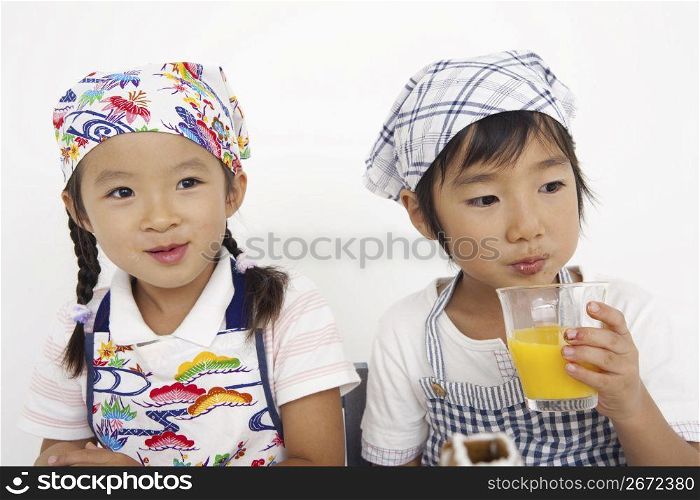 Asian children in cooking apron