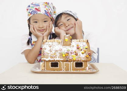 Asian children in cooking apron