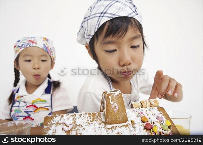 Asian children in cooking apron