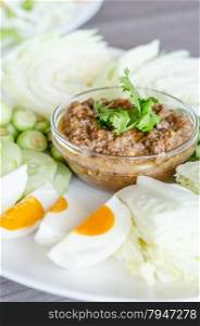 asian chili paste . Thai cuisine chili paste mixed with shrimp served with various vegetables and eggs