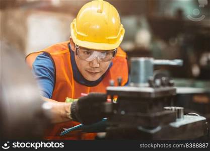 Asian Chinese engineer worker wearing safety suit helmet and eyes protection glasses focus at work inspection and checking production process on factory.