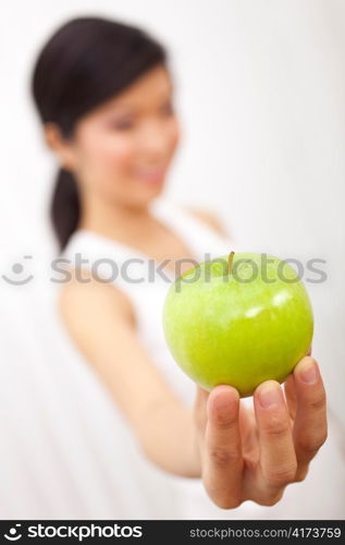 Asian Chinese Girl Holding Fresh Green Apple to Camera