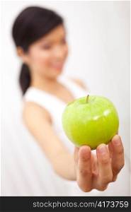 Asian Chinese Girl Holding Fresh Green Apple to Camera