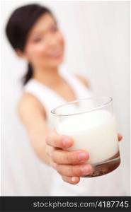 Asian Chinese Girl Holding Glass of Milk to Camera