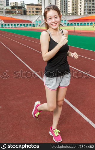 Asian Chinese woman at stadium jogging