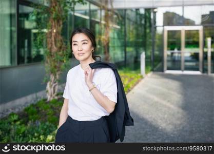 Asian confident business woman in suit, jacket on shoulder. Job, work aspirations concept, background of office center. Business people lifestyle. Copy space. Asian confident business woman in suit. Job, work concept, copy space