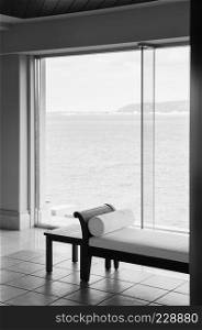 Asian Contemporary style daybed with ocean view through bay window in black and white
