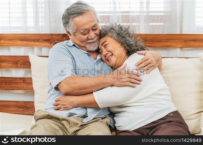 Asian couple Grandparent embracing or hugging together with happy feeling in house, romantic and lover with valentine or anniversary, Long live and Elderly society, Warm family and happiness concept