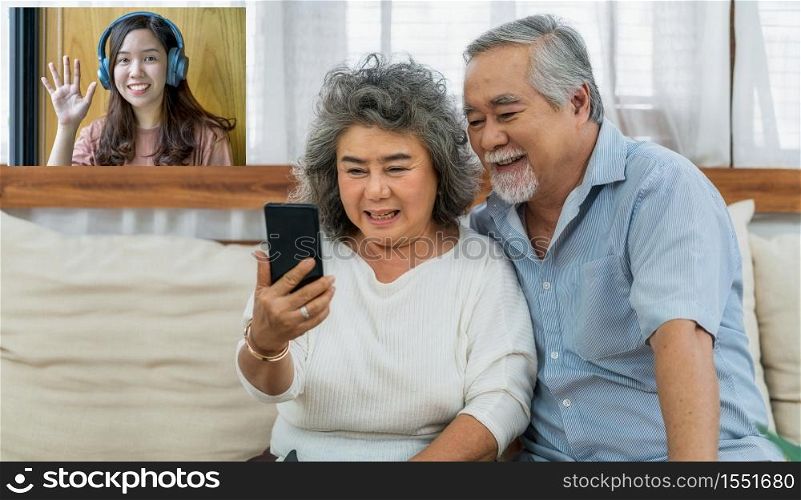 Asian couple Grandparent taking Video call to grandchild woman with happiness feeling by mobile phone in house, Long live and Elderly society,Warm family and happiness,social distancing concept