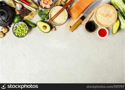 Asian cuisine ingredients on concrete background, top view. Vegetables, spices, shrimp, noodles, rice, sauces for cooking vietnamese, thai or chinese food. Clean eating food concept