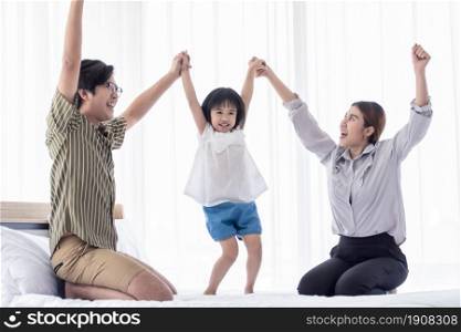Asian cute family spending happy time on holidays and playing together at home