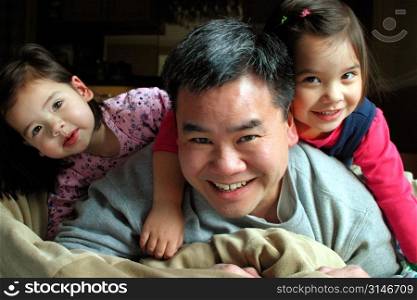 Asian Dad Playing With His Daughters