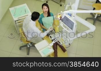 Asian dentist visiting girl in dental studio with tools and equipment, people and oral hygiene, health care and medicine in clinic lab. 18of19
