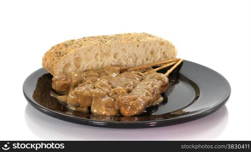 asian dish with bread and sate on white background