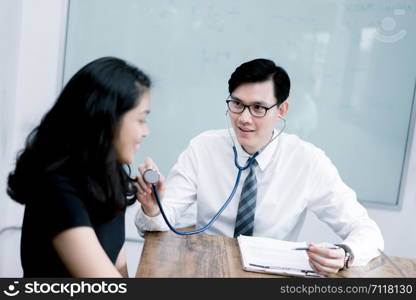 Asian Doctor and patient discussing something while sitting at the table . Medicine and health care concept